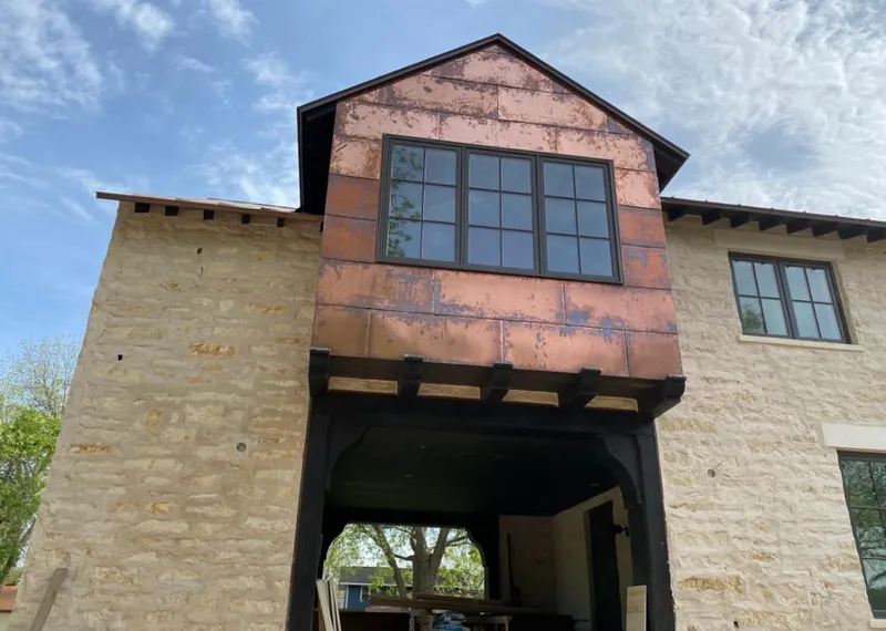 Copper metal panel facade on a stone building for Skylight Installation in Mendota