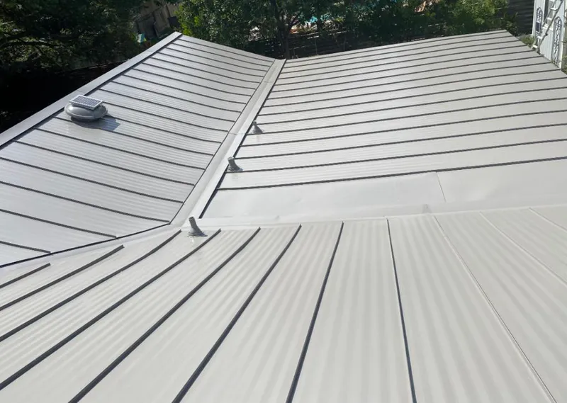 Solar attic fan installed on a metal roof for Roof Ventilation in Mendota
